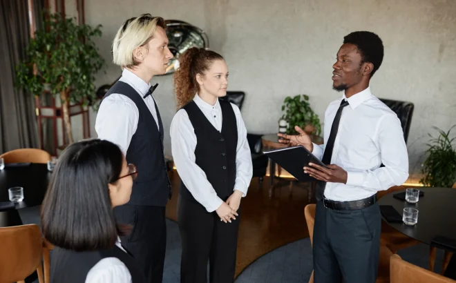 side-view-portrait-young-black-man-as-restaurant-manager-talking-servers-wearing-classic-uniforms-morning-instructions-1536x1024 side-view-portrait-young-black-man-as-restaurant-manager-talking-servers-wearing-classic-uniforms-morning-instructions-1536x1024